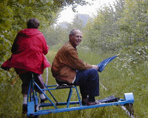 Two persons on a railway trolley. Photo.