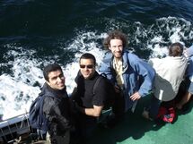 Three persons on the ferry. Photo.