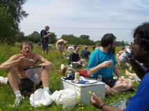 People having lunch in the grass. Photo. 