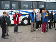 People standing outside a buss. Photo.