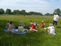 People having lunch in the grass. Photo. 