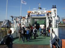 People entering a ferry. Photo. 