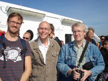 Three persons on the ferry. Photo.